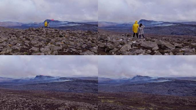 在广阔的岩石场上冒险家的无人机视图中，火山爆发在框架中