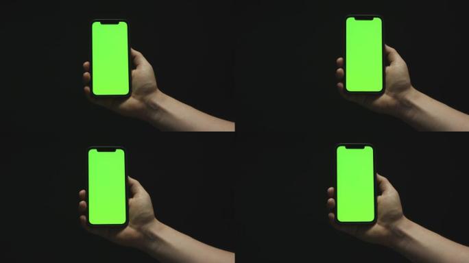 手持黑底绿屏智能手机
