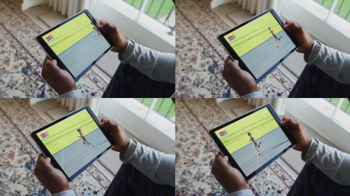 男人坐在家里，在平板电脑上观看田径比赛的合成