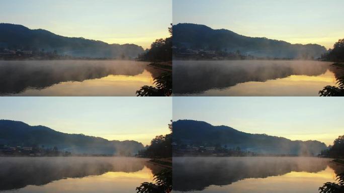 大自然中的美丽早晨日出，在泰国湄宏顺班拉泰村，河湖雾雾蒙蒙，反射水面和乡村山