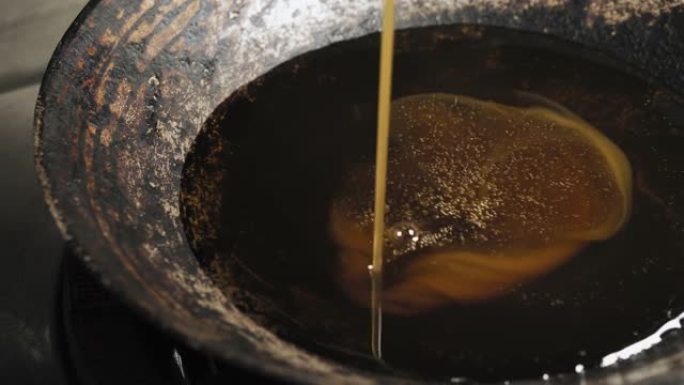 油倒在一个大黑锅上。传统感觉。