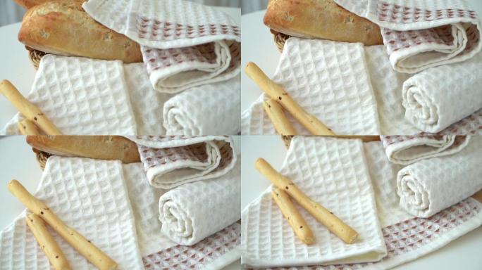华夫饼干新鲜厨房毛巾的相机运动背景是带面包的篮子。棉质洗碗巾。茶巾。纺织业。