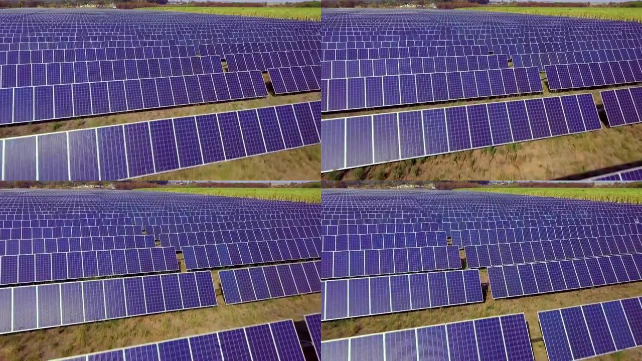 在大面积上产生清洁能源的数百个太阳能模块或成排的面板的航拍图像。空中无人机的观点