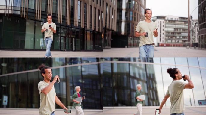 平移慢动作拍摄的自信的年轻人走在城市街道上，在手机上发短信，喝外卖咖啡，微笑着无忧无虑。手提电脑走在