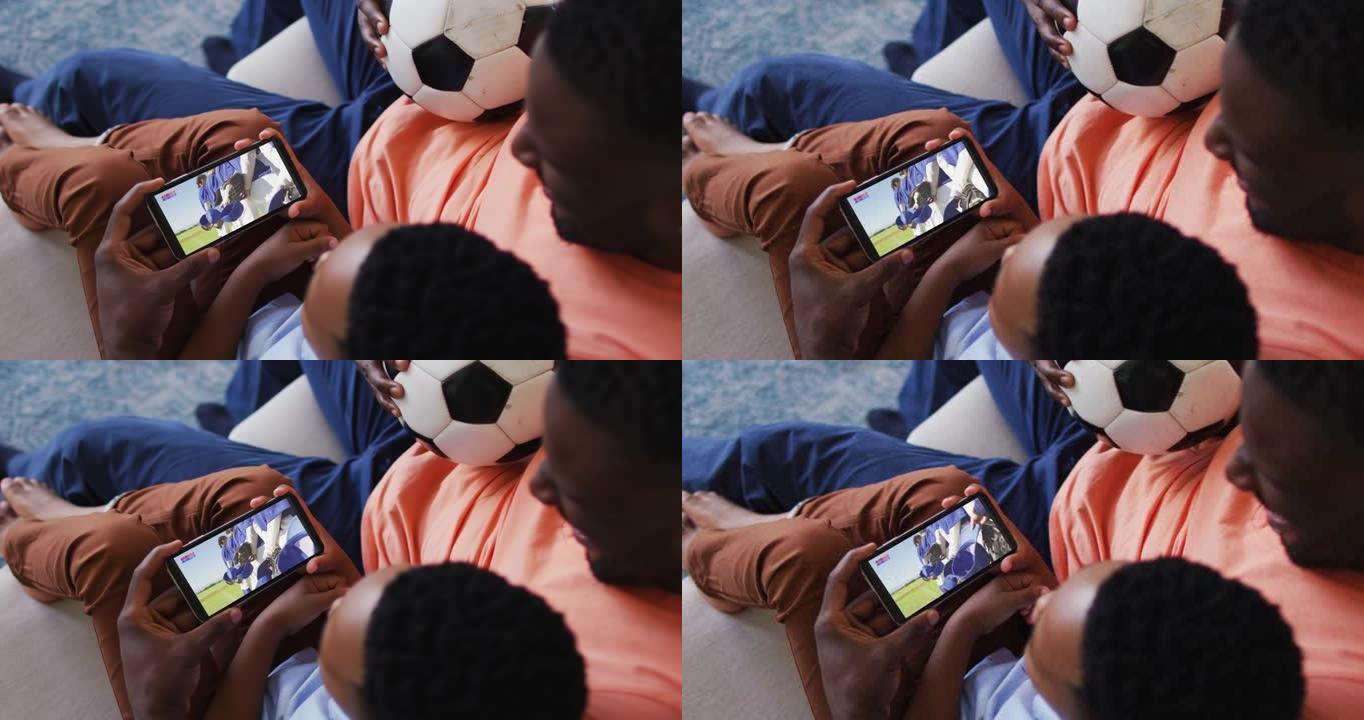 父亲和儿子的合成在智能手机上观看棒球比赛