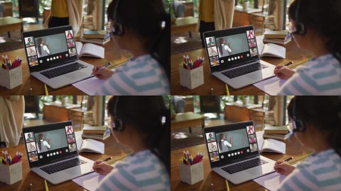 女孩在家做作业并与老师和同学在笔记本电脑上进行视频会议