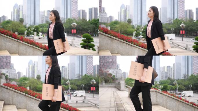 气质女白领拿投标文件 商务女士上楼梯