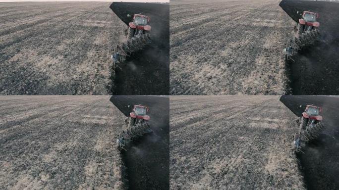 拖拉机耕地的无人机视图。