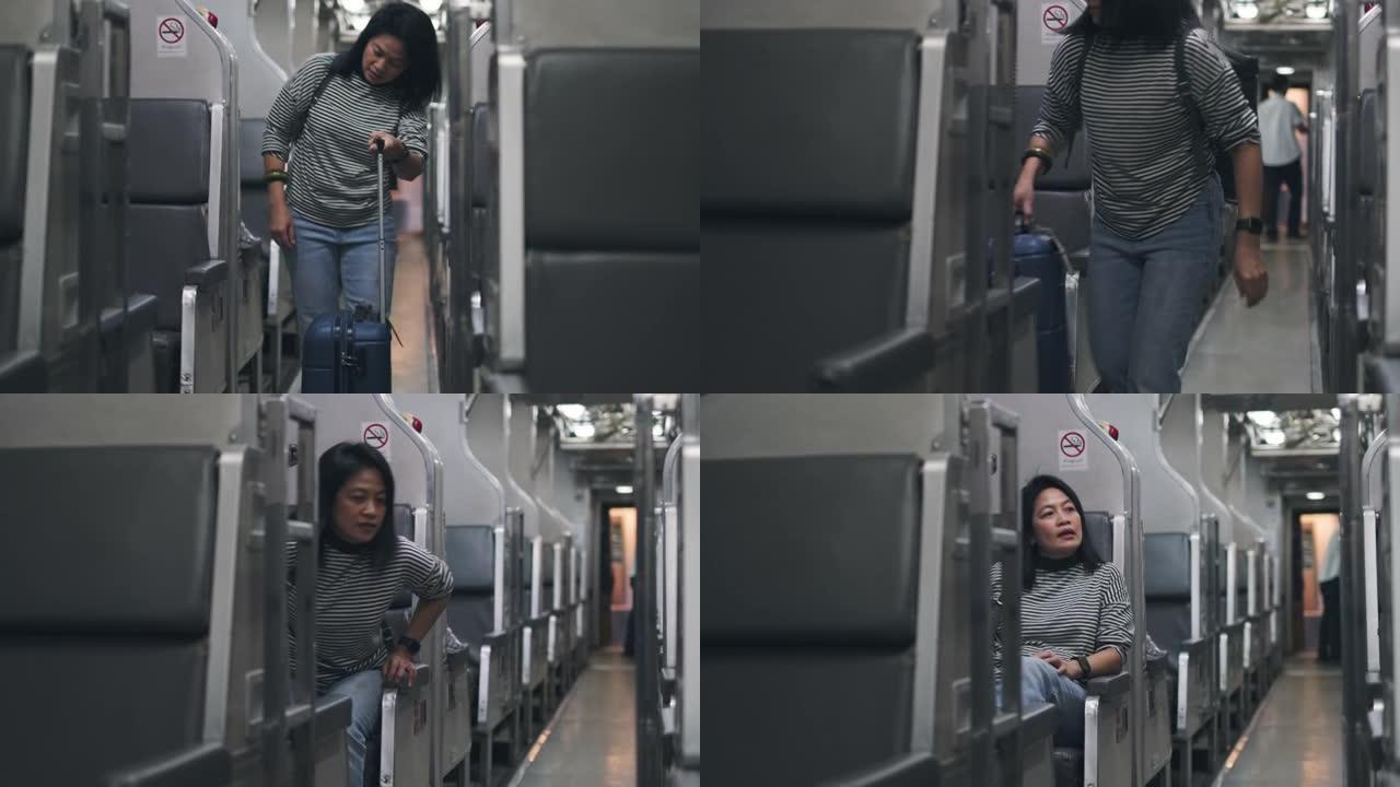 亚洲妇女带着手提箱在火车上的人行道上行走