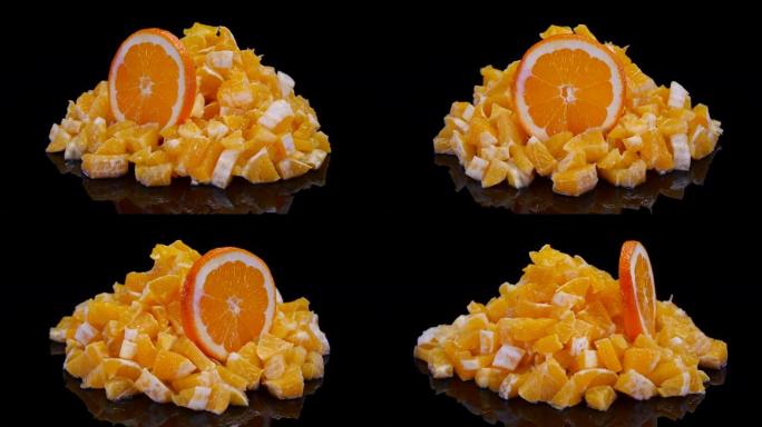 黑色背景上的橙色和橙色切片。4K新鲜，完美，多汁的有机橙子。