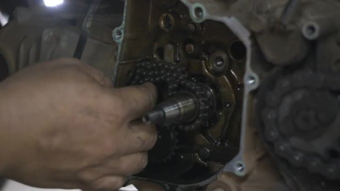 机械师在摩托车发动机上戴上链条磁轮机械师