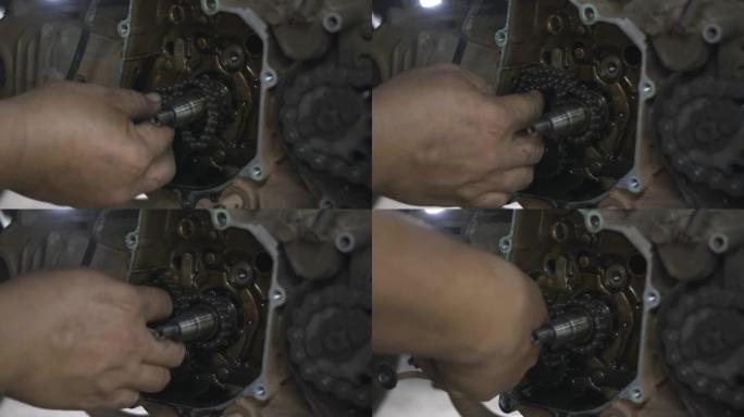 机械师在摩托车发动机上戴上链条磁轮机械师
