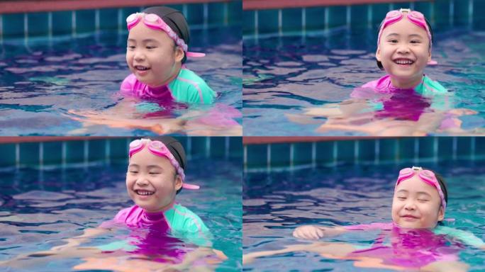 在蓝色游泳池玩耍的亚洲女孩。