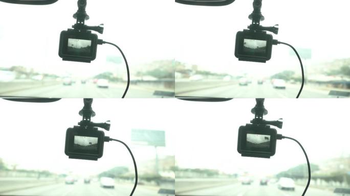 挂在汽车挡风玻璃上的行车记录仪的特写镜头记录了旅行的路线