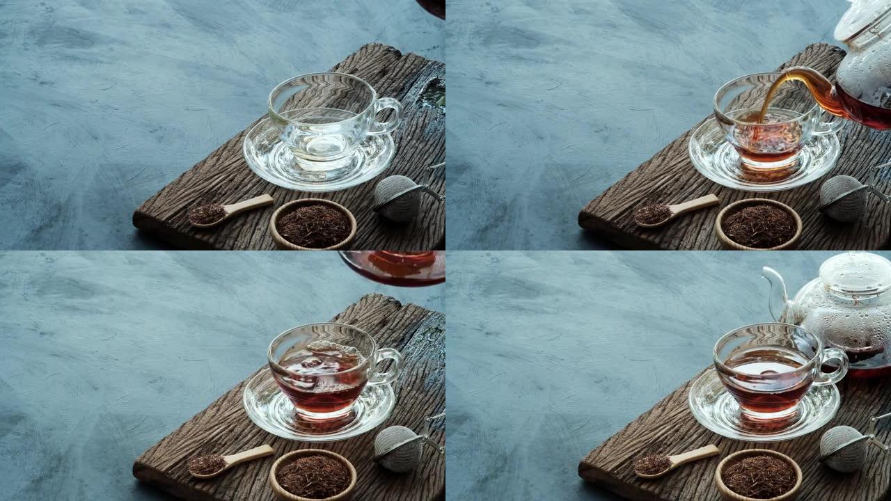 过程冲泡茶，将热茶水从茶壶倒入杯子中，放在带有深色厨房餐桌背景的旧木板上，静物放松时光阴暗的心情风格