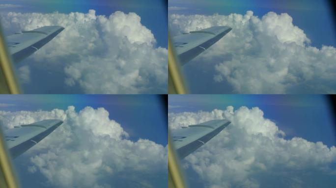 窗户上云层上方的飞机机翼视图
