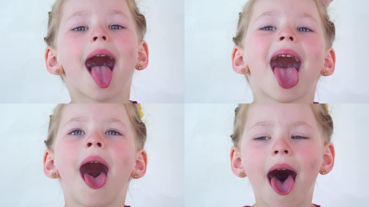 一个小女孩露出舌头喉咙。张大嘴，舌头突出的肖像。视野清晰，伸出长长的舌头。牙医的软腭和嘴巴。嘴巴张开