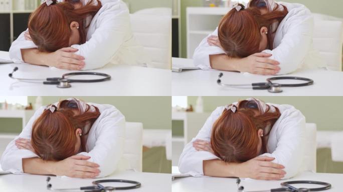 4k视频片段，一名女医生头躺在办公室的桌子上