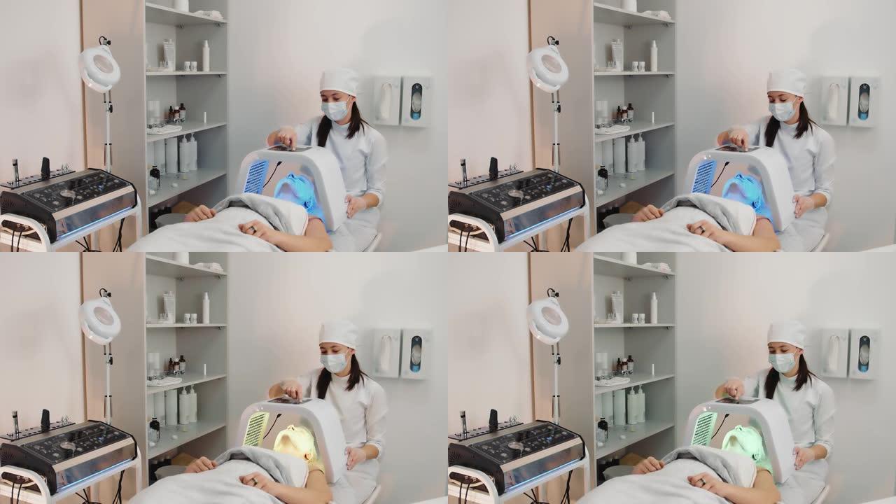 美容院美容师对患者面部进行LED疗法