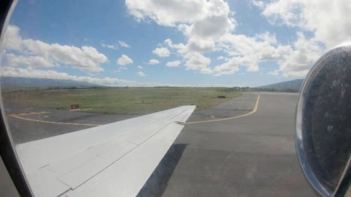 飞机窗外的时间流逝。飞机在夏威夷毛伊岛国际机场征税和起飞。
