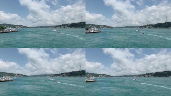 伊斯坦布尔高档社区 “Arnavutkoy” 在博斯普鲁斯海峡经过的游艇和船只的镜头。在阳光明媚的夏