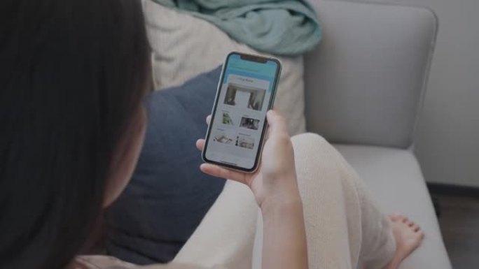 女人用手机上的智能家居应用程序设置房间照明