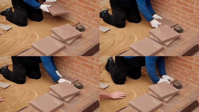 专业工人在压制的沙子上铺设瓷砖。慢动作俯视图futage