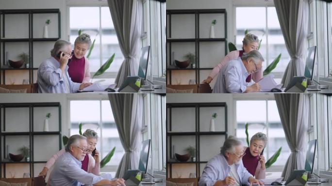 老高级亚洲退休人士企业家在家一起工作，在家隔离远程工作与桌面和智能手机技术设备在家工作