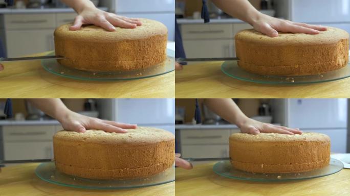 女人的手切开烤饼干做甜蛋糕。