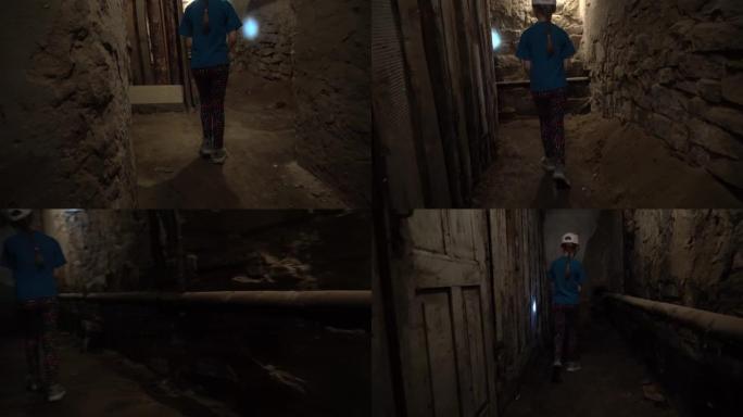穿过一个古老的黑暗地下地下室或老房子里的壁橱。旧庄园里有许多门的旧地下通道。阴沉的走廊或有石墙的隧道