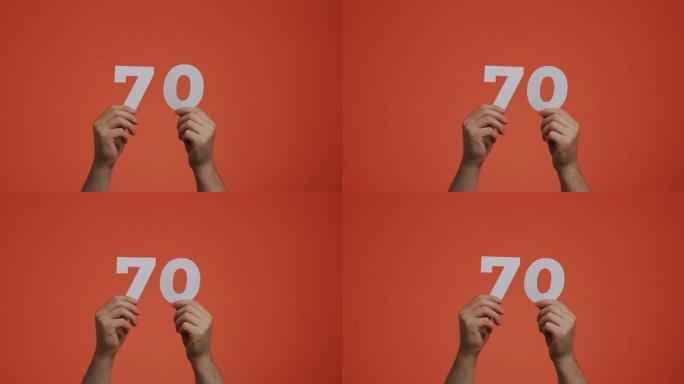70号在手。显示数字的人，70个由雕刻纸制成，用于投票或数学学习