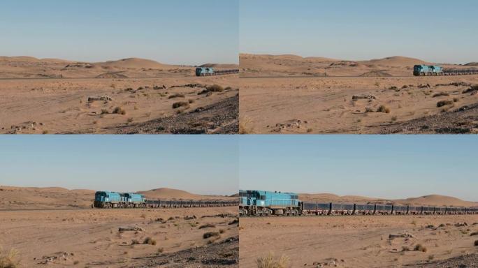 沙质沙漠中的铁轨上的货物列车