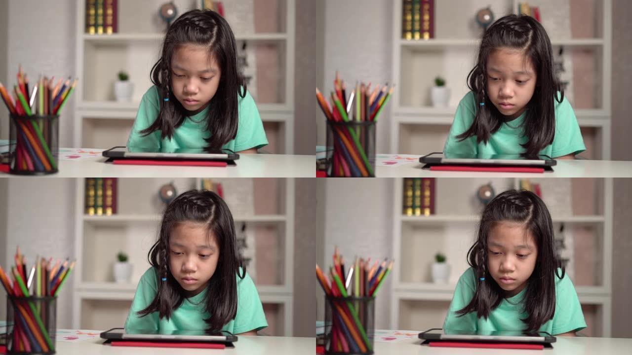 亚洲小女孩在平板电脑上看动画片，小孩使用数字平板电脑