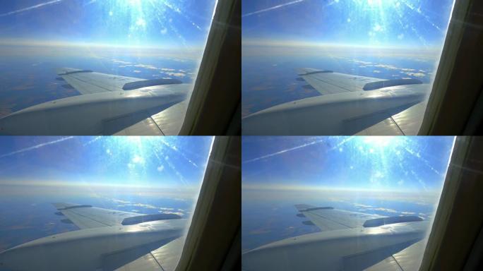 飞行过程中窗户中的太阳和飞机机翼
