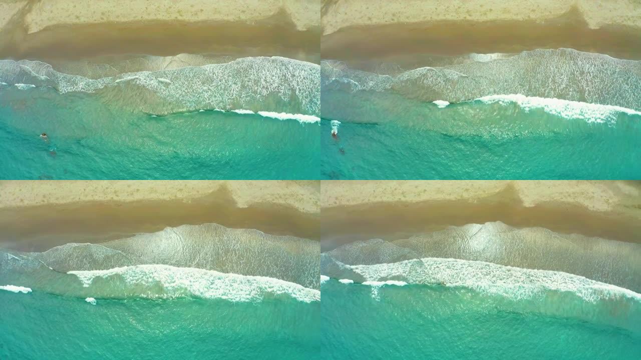 海浪冲刷海滩沙滩的鸟瞰图