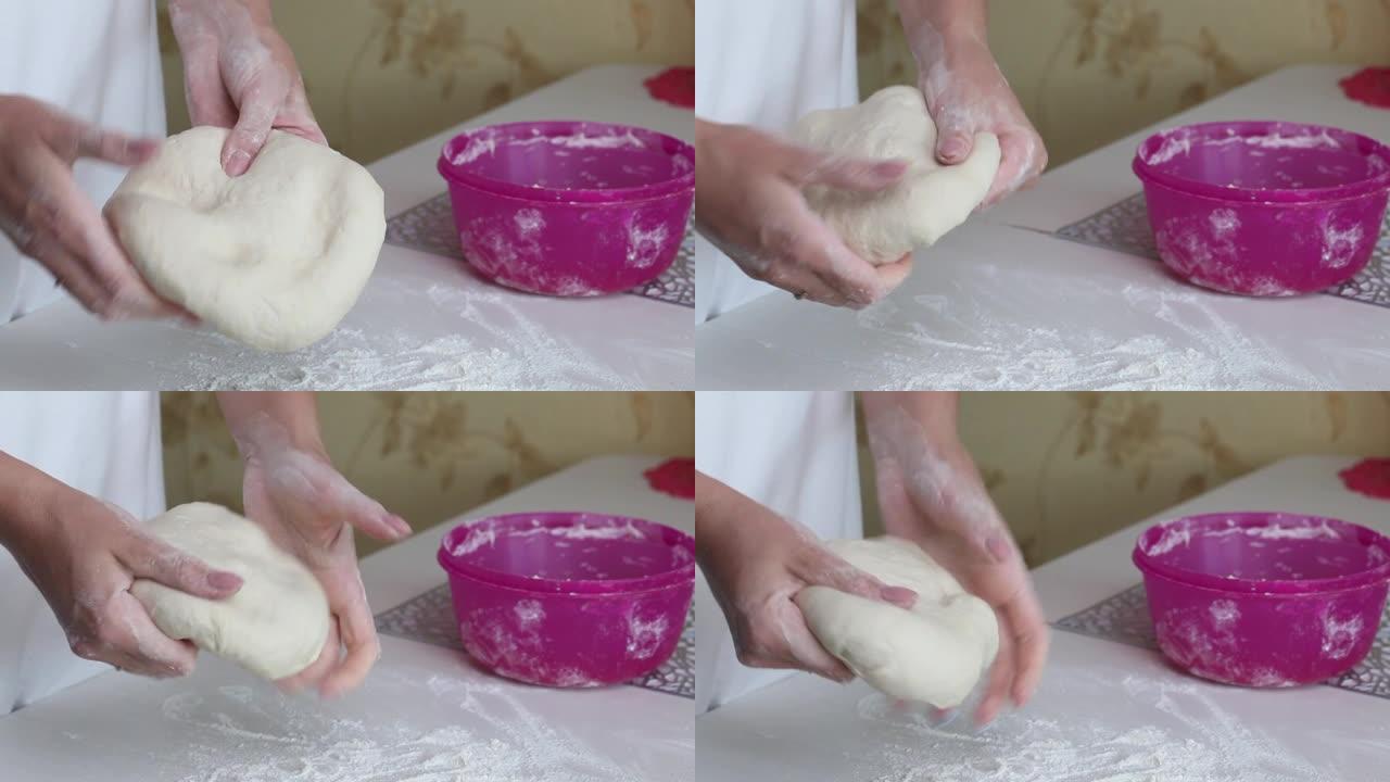 一个女人在手里揉着饺子的面团。用土豆和肉末煮饺子。特写镜头。