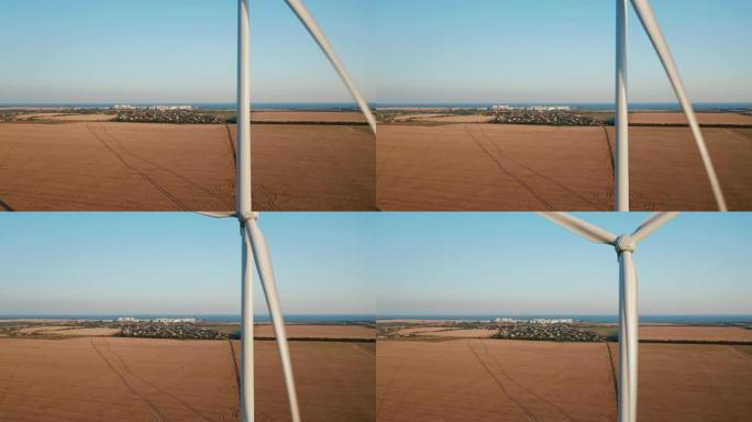 一种风力涡轮机，在日落时在农业土地上运行并发电。