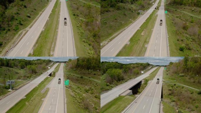 空中无人机拍摄卡车在转弯的道路上行驶。