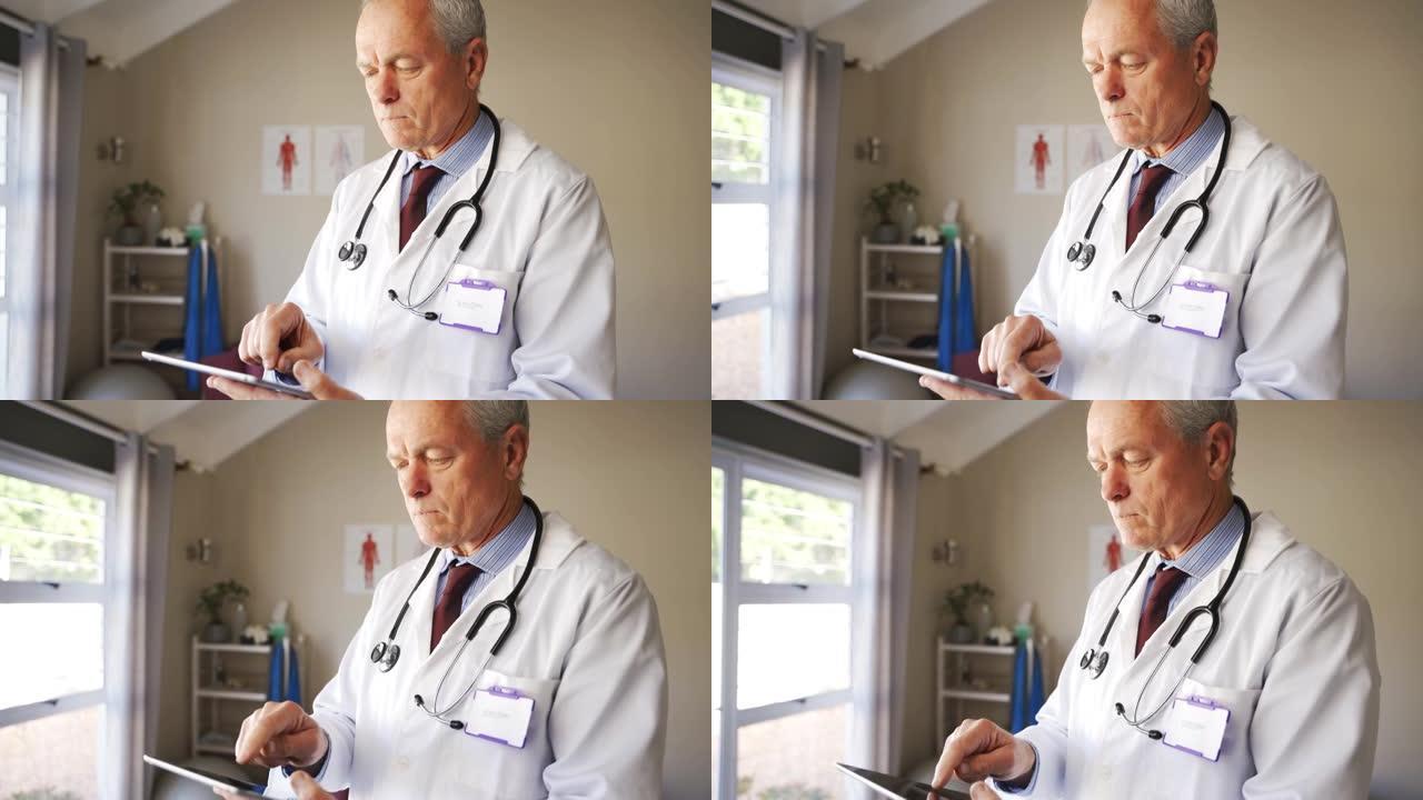 白种人男医生在数字平板电脑上刷卡提交了患者的测试结果，站在诊所
