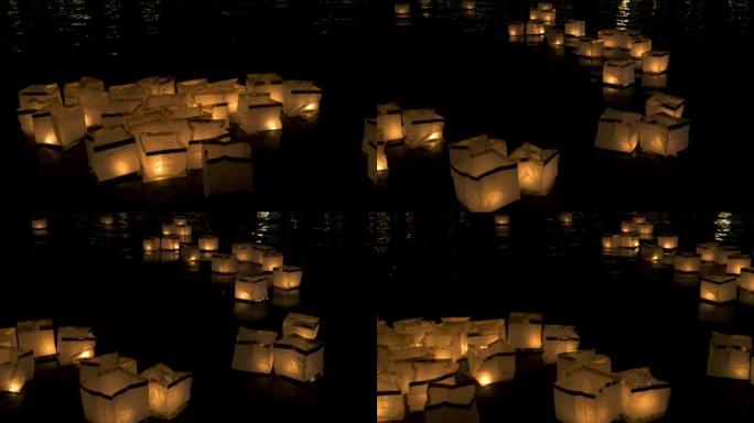 漂浮在伏尔塔瓦河水面上的纸灯笼的光照亮了布拉格的黑暗