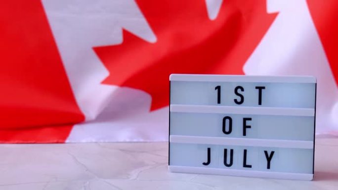 4k加拿大国旗。带有文字加拿大7月1日国旗或枫叶的灯箱。爱国主义。国际关系概念。独立日