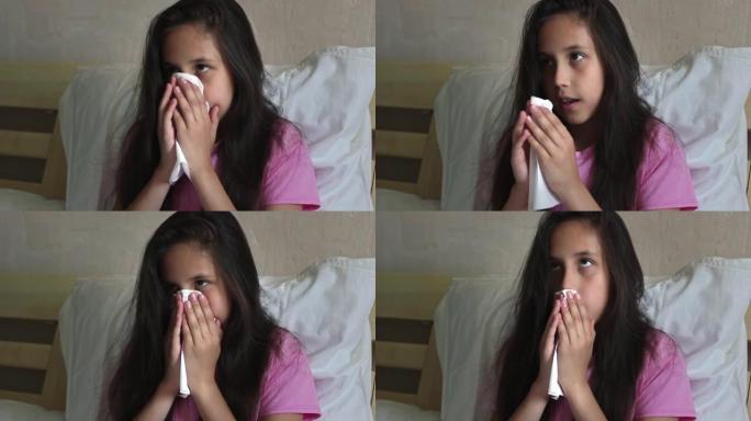 一个穿着粉红色t恤的黑发可爱的女孩坐在床上，生病，打喷嚏或用餐巾纸擦拭鼻子