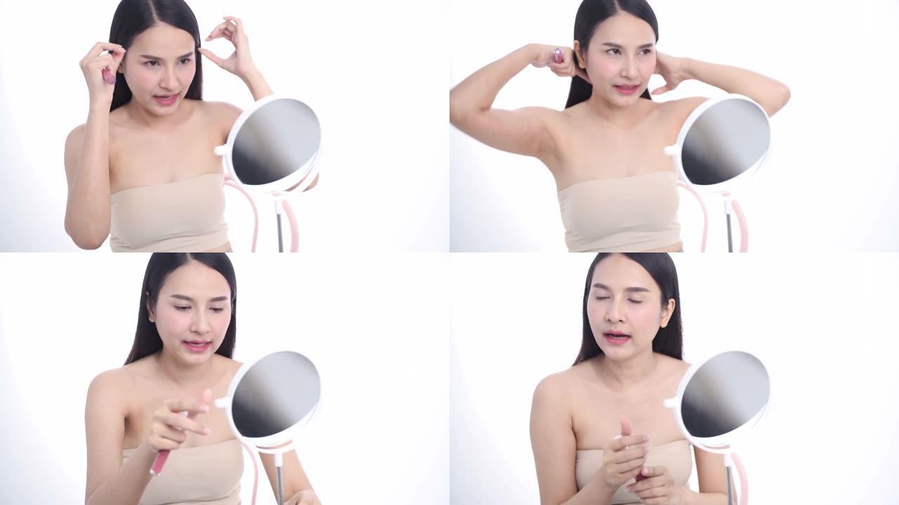 亚洲女性博客作者正在展示如何化妆和使用化妆品。在摄像机前录制工作室的vlog视频直播