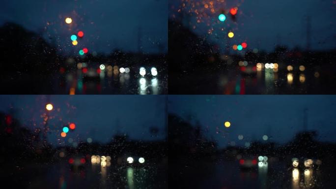 红色交通信号灯。汽车后视镜上的雨滴。在雨夜开车。交通中聚焦模糊的光线，小雨水撞击前后视镜。视频慢动作