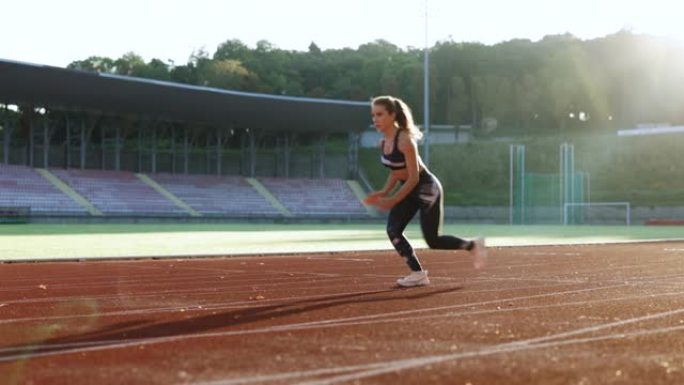 女运动员在跑道上开始冲刺。跑步者从跑道上的起跑点起飞。慢跑者活动。女运动员。女运动员。有氧运动。锻炼