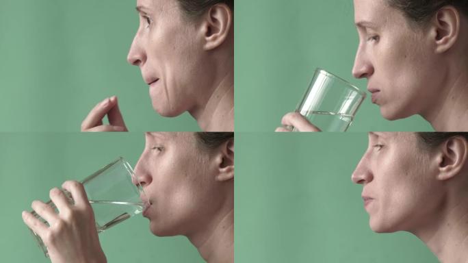 女人吃药喝水。特写。高质量全高清镜头。25FPS，缩小