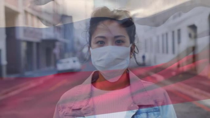 俄罗斯在街上挥舞旗帜反对戴着口罩的亚洲妇女的肖像