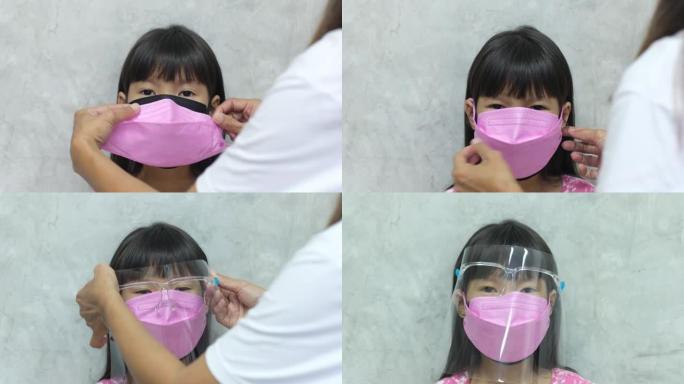 母亲帮助女儿戴上双重面具，并用面罩保护女儿