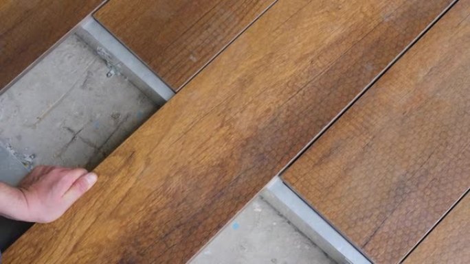 修理木板连接的家庭甲板地板。木匠设置甲板地板木板。地板安装工程建筑家居装修建筑木质甲板木板地板覆盖物
