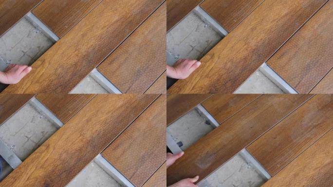 修理木板连接的家庭甲板地板。木匠设置甲板地板木板。地板安装工程建筑家居装修建筑木质甲板木板地板覆盖物